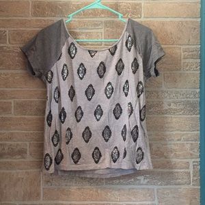 A grey top with sequenced diamonds on the front.